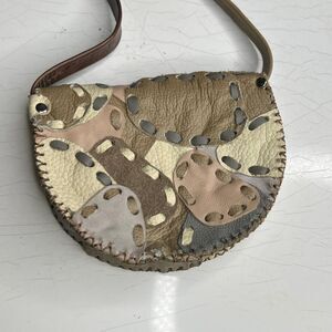 handmade, upcycled leather patchwork crossbody saddle bag with an adjustable str